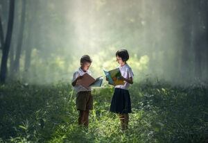 Children reading in forest