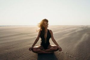 Woman meditating in the desert