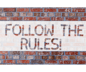 Graphic of a brick wall with a text overlay saying "FOLLOW THE RULES!"