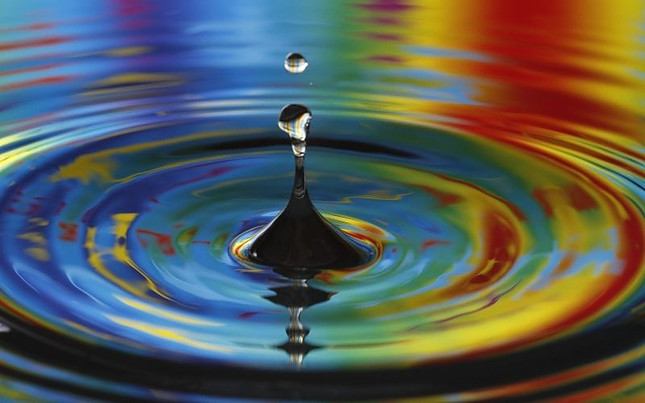 Image shows a drop falling into a body of water, causing concentric ripples